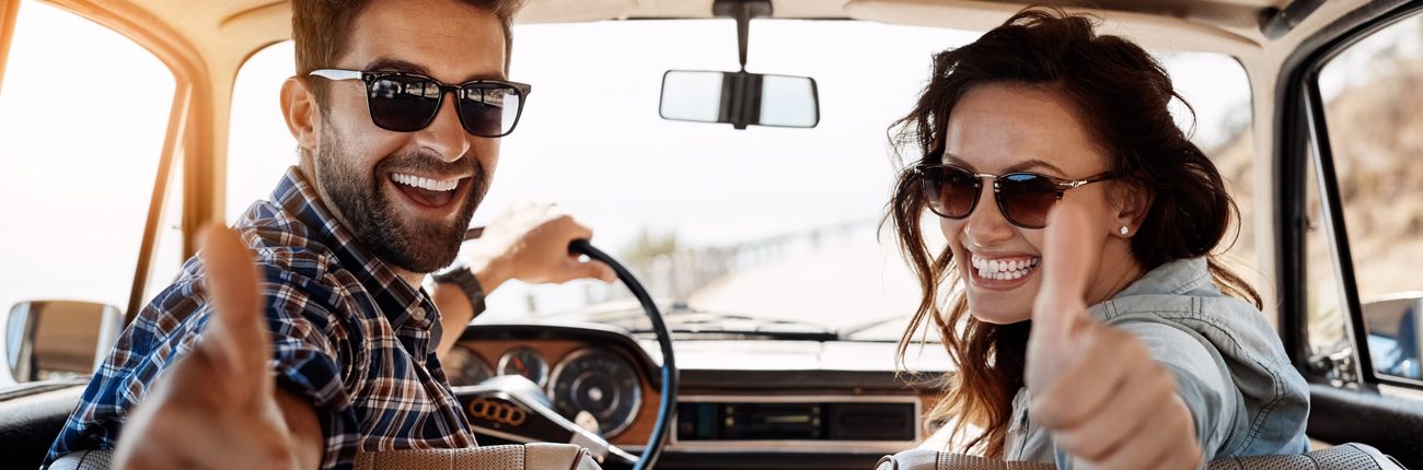 Couple heureux dans sa voiture pour partir en vacances